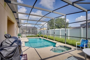 A covered outdoor swimming pool with a patio area, including a barbecue grill and seating. - Florida Retreat w/ Pool, Hot Tub & Near Disney! (Davenport)