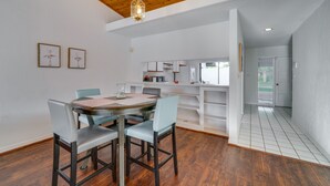 A dining area with a wooden ceiling, a round table with chairs, and a kitchen in the background. - Waterfront Haines City Vacation Rental w/ Pool! (Haines City)