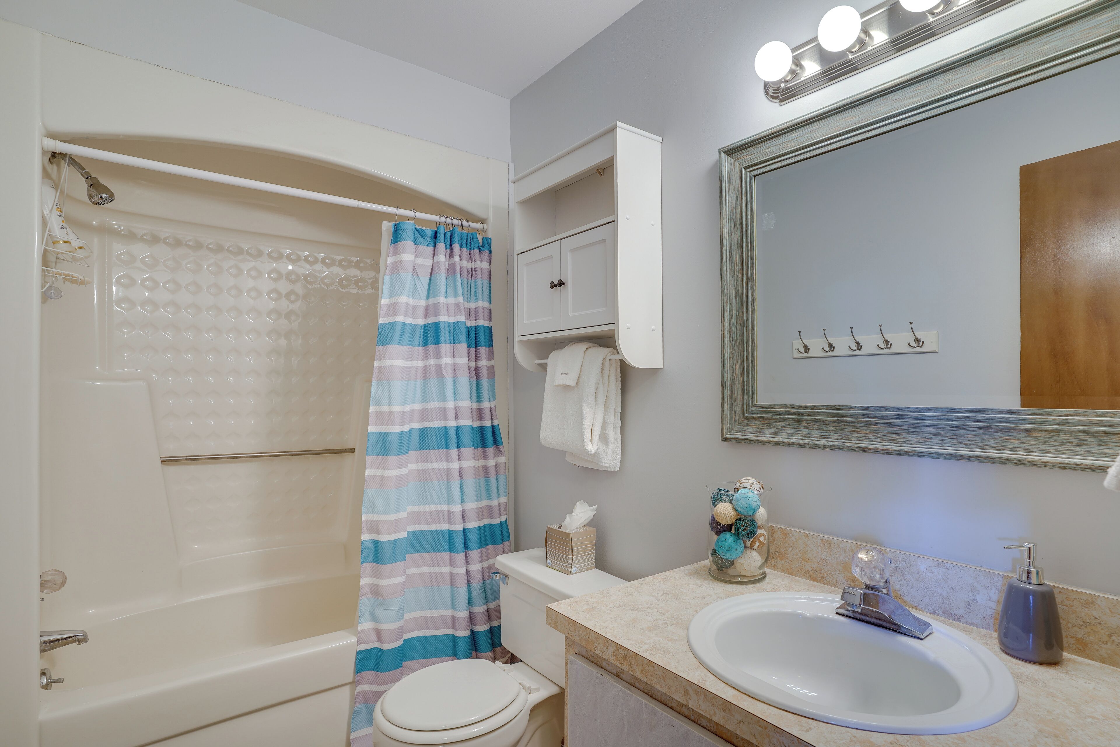 A bathroom with a bathtub, toilet, and sink.