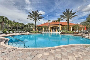 A swimming pool with a tiled deck, palm trees, and lounge chairs. - Game Room & Pool: Family-friendly Davenport Home! (Davenport)