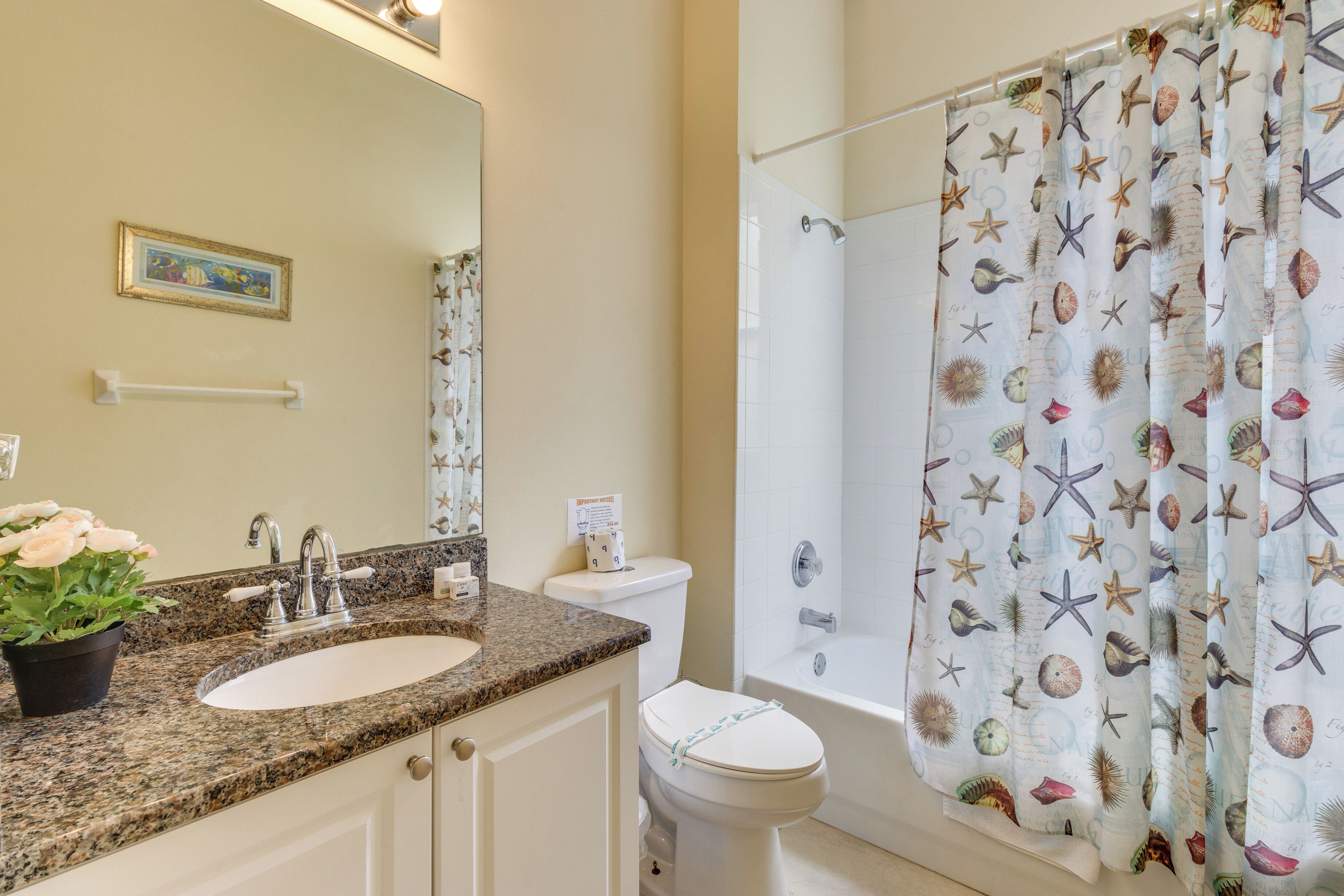 A bathroom with a sink, toilet, and bathtub.