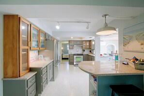 A modern kitchen with granite countertops, stainless steel appliances, and wooden cabinets. - Private Dock & Lanai: Waterfront Cape Coral Home! (Cape Coral)