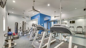 A modern gym with treadmills, elliptical machines, and free weights. - South Padre Island Gem: Community Pool & Hot Tub! (South Padre Island)