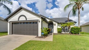A single-story house with a garage, a front door, and a small porch. - Davenport Vacation Rental w/ Private Pool! (Davenport)