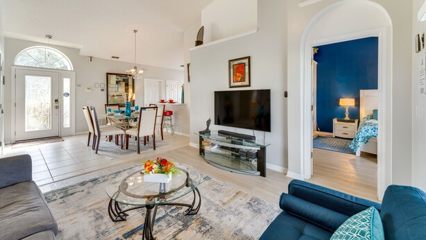A spacious living area with a dining table, a TV, and a cozy seating arrangement. - Davenport Vacation Rental w/ Private Pool! (Davenport)