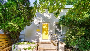 A house with a yellow door, a brick pathway leading to the front, and a wooden fence on the left. - Salt Lake City Escape: Walk to University of Utah! (Salt Lake City)