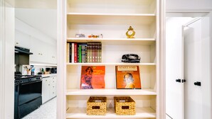 A kitchen with white cabinets, a black stove, and a patterned floor. - Salt Lake City Escape: Walk to University of Utah! (Salt Lake City)