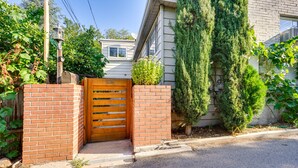 A residential property with a brick entrance gate, a mailbox, and a small garden with various plants. - Salt Lake City Escape: Walk to University of Utah! (Salt Lake City)