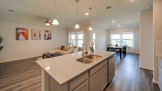 A spacious kitchen with a central island, a dining area with a table and chairs, and a living room with a sofa and decorative wall art. - San Antonio Getaway w/ Private Yard & Smart TV (San Antonio)