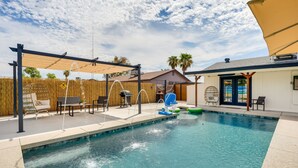 A backyard with a swimming pool, outdoor seating, and a covered patio area. - Glendale Getaway: Swim, Putt, Grill, & Relax! (Glendale)