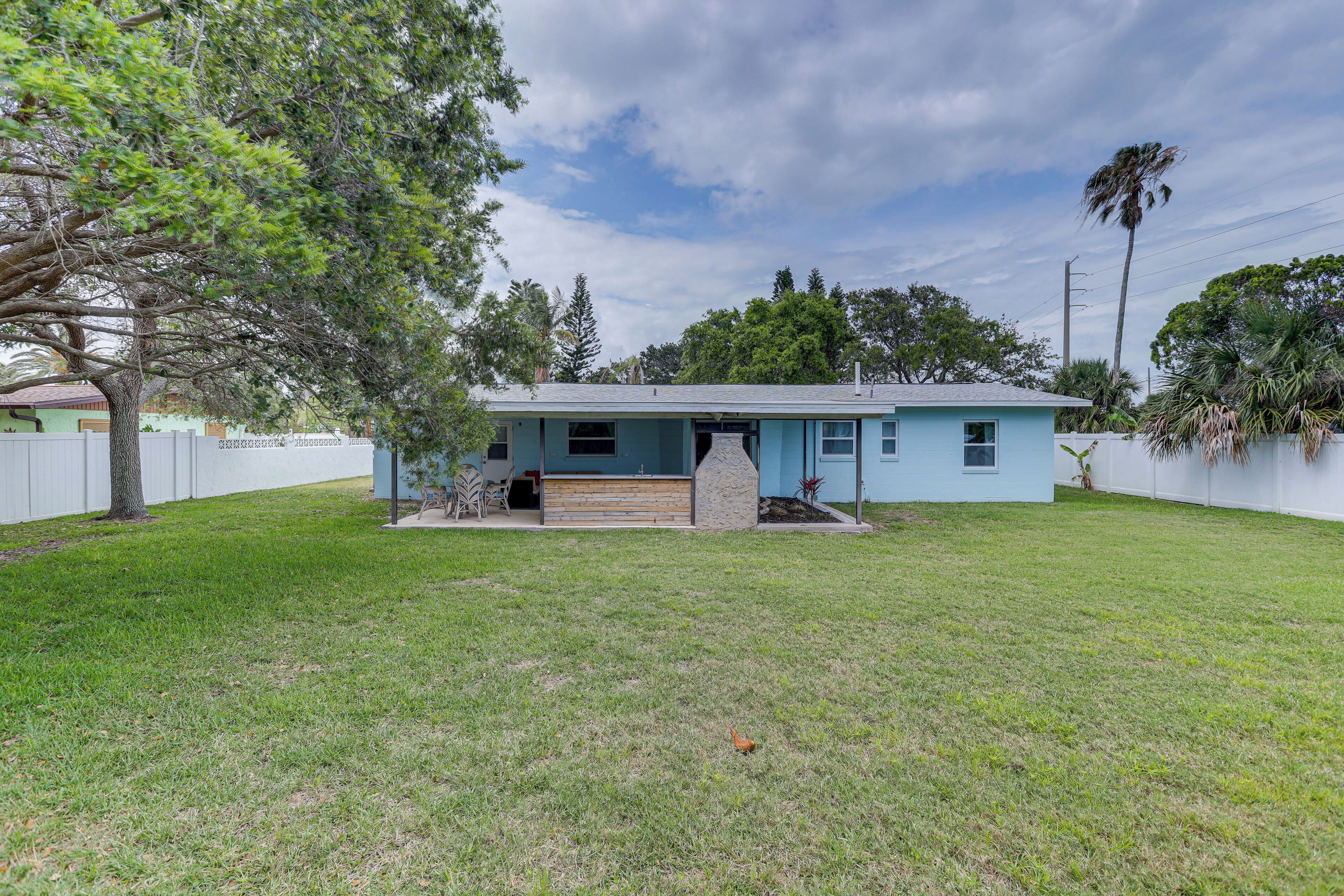 A single-story house with a front porch, a small stone feature, and a well-maintained lawn.