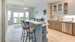 Una cocina moderna con una isla central, taburetes de bar y armarios de madera.