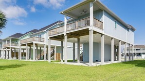 A beachfront property with multiple levels, balconies, and a covered outdoor area. - Near Terramar Beach! Family Getaway w/ Balcony (Galveston)