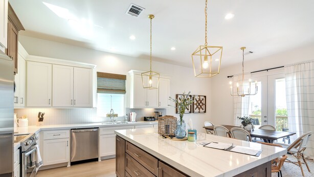A modern kitchen with white cabinetry, stainless steel appliances, and a large island. - Near Terramar Beach! Family Getaway w/ Balcony (Galveston)