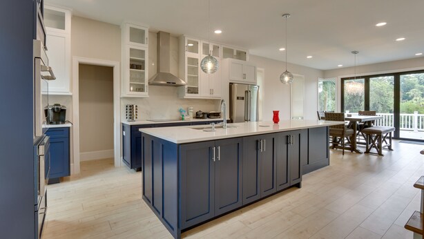 A modern kitchen with a large island, built-in cabinets, and pendant lighting. - Family-friendly Hilton Head Island Getaway w/ Deck (Hilton Head Island)