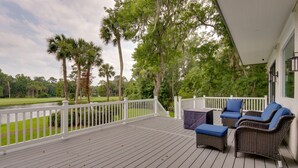 A wooden deck with outdoor furniture, a white railing, and a view of a golf course. - Family-friendly Hilton Head Island Getaway w/ Deck (Hilton Head Island)