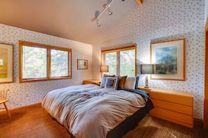 A bedroom with a large bed, two bedside tables, a chair, and two windows with blinds. - Pet-friendly Park City Condo w/ Private Hot Tub! (Park City)