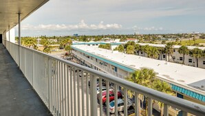 A balcony with a view of a parking lot and buildings. - Ocean Jewels Resort Studio w/ Community Perks! (Daytona Beach)