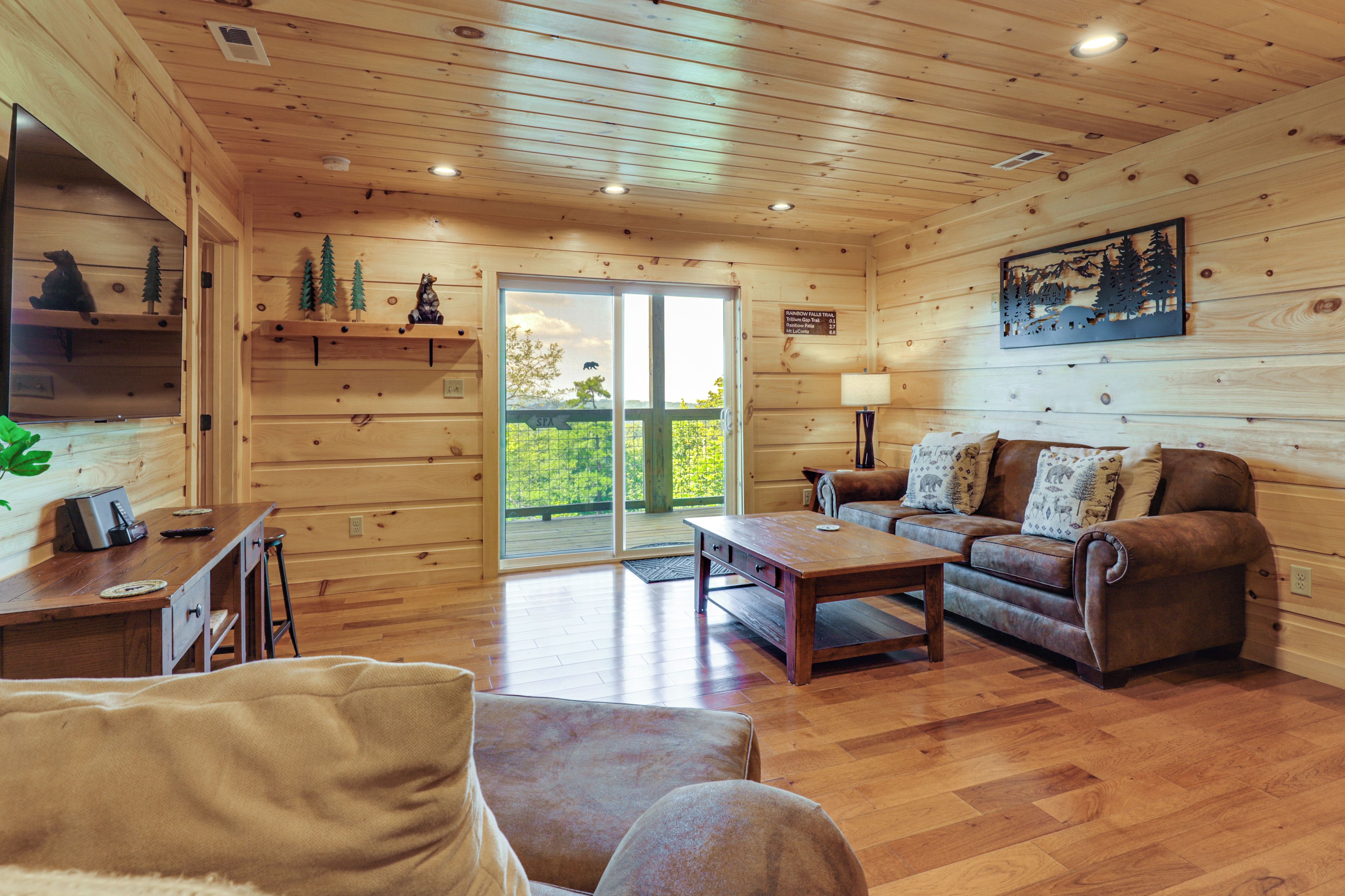 A wooden interior with a sofa, coffee table, and a fireplace.