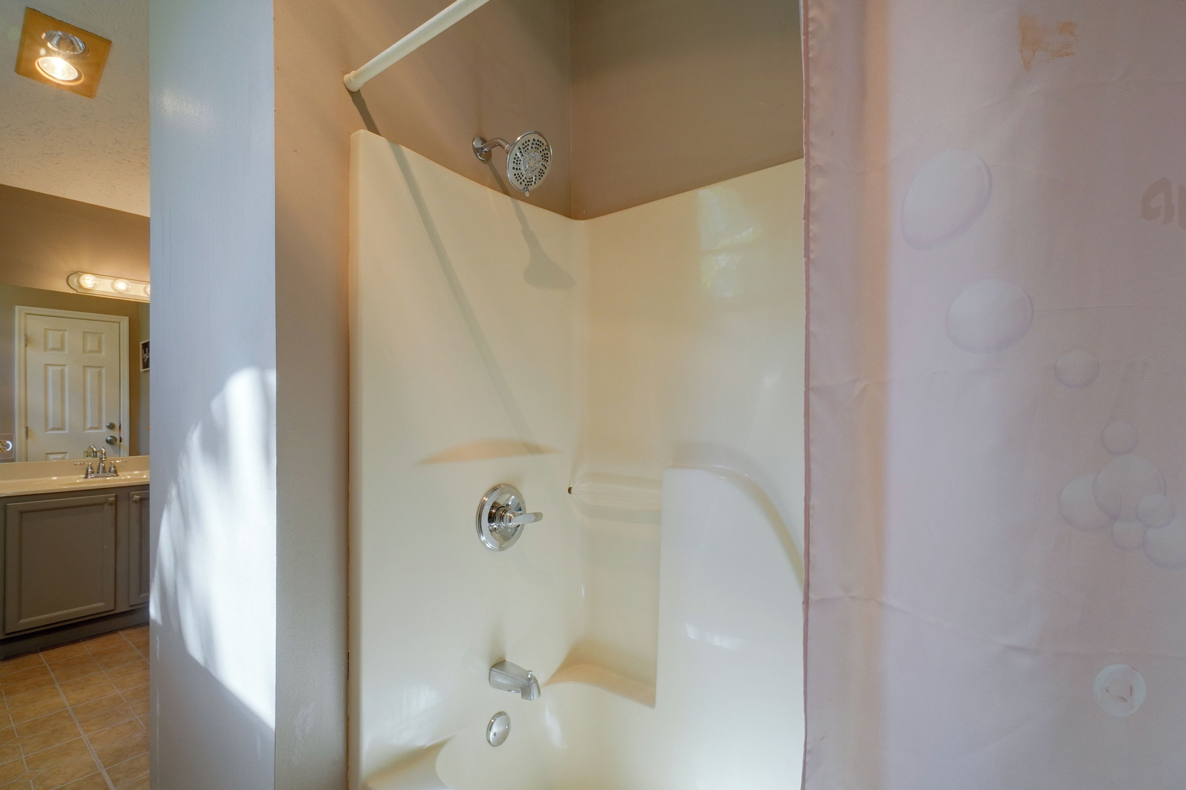 A bathroom with a bathtub, a shower, and a toilet.
