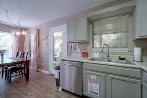 A kitchen with a dishwasher, sink, and a fire extinguisher sign. - Smoky Mtn Cabin w/ Hot Tub Near Ober Gatlinburg (Gatlinburg)
