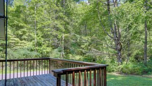 A wooden deck with a railing overlooking a forested area. - Wooded Cabin w/ Pool Table Near Dtwn Gatlinburg! (Gatlinburg)