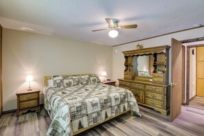 A bedroom with a bed, nightstands, a dresser, a ceiling fan, and a mirror. - Wooded Cabin w/ Pool Table Near Dtwn Gatlinburg! (Gatlinburg)