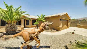 A dinosaur statue in a courtyard with a building in the background. - Outdoor Oasis: Home w/ Hot Tub in Lake Havasu City (Lake Havasu City)
