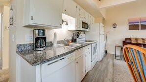 A modern kitchen with white cabinets, a granite countertop, a coffee maker, and a microwave. - Branson Vacation Rental w/ Loft ~ 4 Mi to Downtown (Branson)