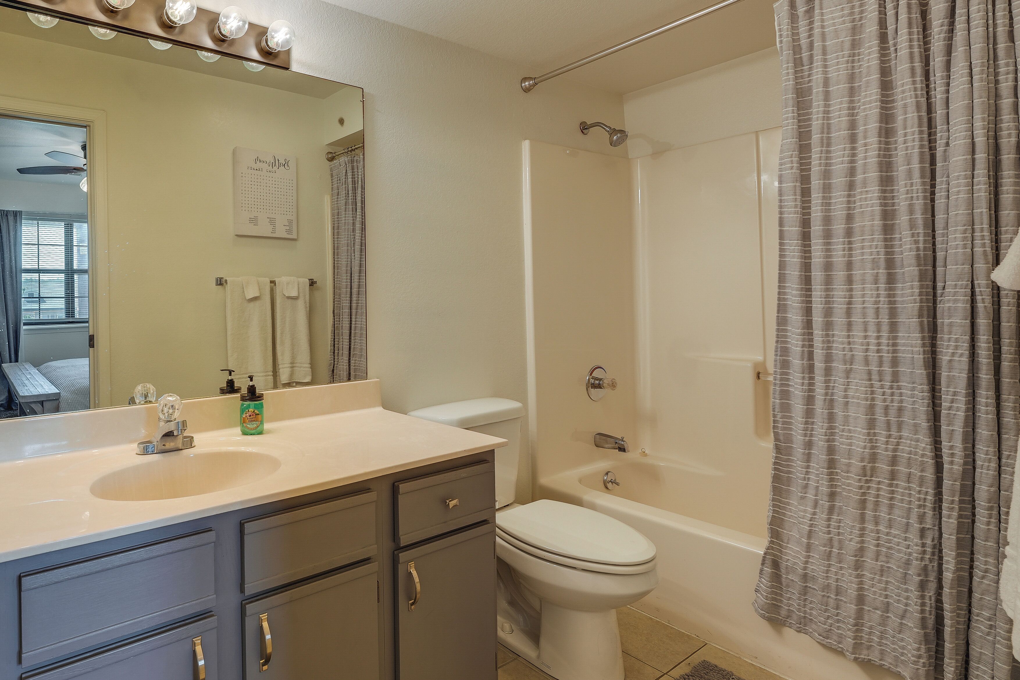 A bathroom with a sink, toilet, and bathtub.