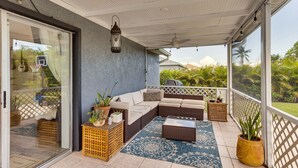 A covered outdoor seating area with a sofa, coffee table, and potted plants. - Port St Lucie Oasis w/ Heated Saltwater Pool! (Port Saint Lucie)