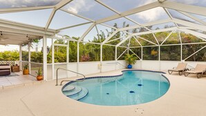 An indoor swimming pool with a glass ceiling, surrounded by lounge chairs and potted plants. - Port St Lucie Oasis w/ Heated Saltwater Pool! (Port Saint Lucie)