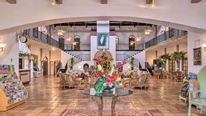 A spacious lobby with a central round table, multiple seating areas, and a staircase leading to an upper level. - Naples Vacation Rental w/ Grill, Resort Pool! (Naples)