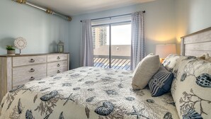 A bedroom with a bed, a dresser, a window with curtains, and a balcony view. - Myrtle Beach Vacation Rental: 1 Mi to Apache Pier! (Myrtle Beach)