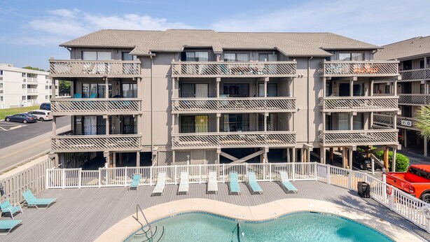 A multi-story hotel with balconies, a pool area, and a street view. - Myrtle Beach Vacation Rental: 1 Mi to Apache Pier! (Myrtle Beach)