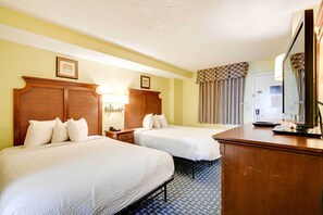 A hotel room with two beds, a wooden dresser, a desk with a mirror, and a lamp. - Waterfront Myrtle Beach Condo, Pool & Ocean Views! (Myrtle Beach)