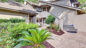 A two-story house with a covered front porch, a small front yard with a palm tree, and a visible staircase leading to the upper level. - Private Deck & Pool Access: Myrtle Beach Getaway! (Myrtle Beach)