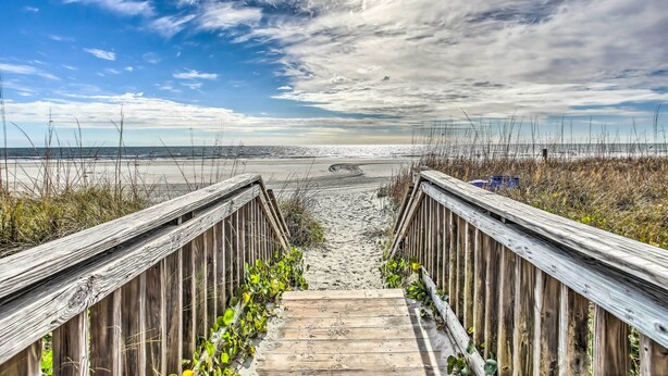 A wooden boardwalk leading to a beach with a clear sky and distant horizon. - Private Deck & Pool Access: Myrtle Beach Getaway! (Myrtle Beach)