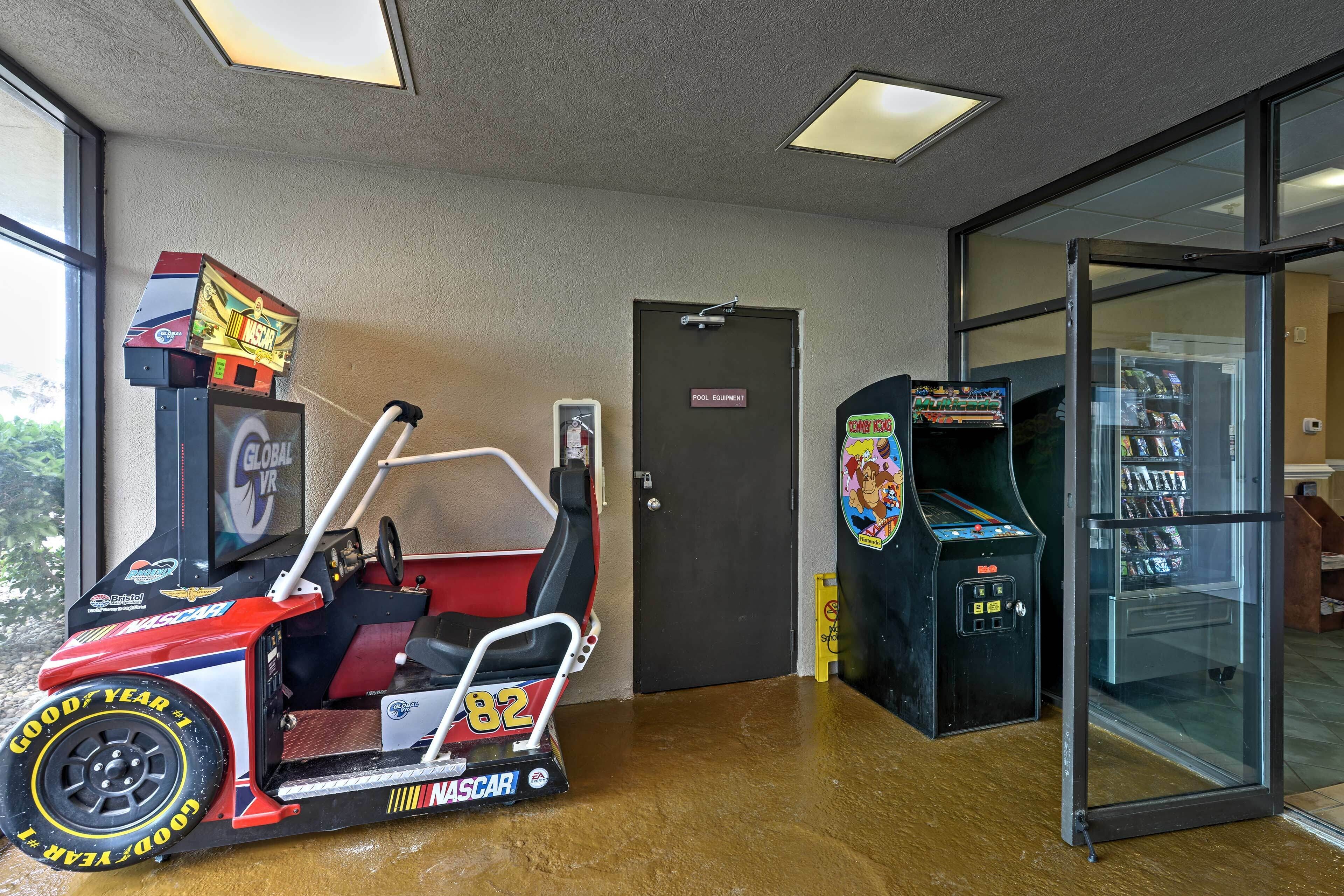 A room with a go-kart, a pool equipment door, and a vending machine.