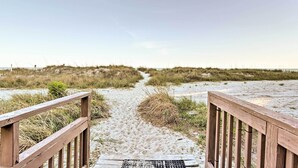 A wooden boardwalk leading to a sandy beach with dunes in the background. - Walk to Coast: North Myrtle Beach Condo w/ Pool! (North Myrtle Beach)