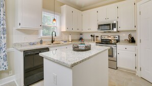 A kitchen with white cabinets, a dishwasher, a microwave, and an oven. - Lakefront Raleigh Retreat ~ 7 Mi to Downtown! (Raleigh)