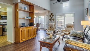 A spacious living room with a wooden entertainment center, leather sofa, and a glass coffee table. - Walk to Restaurants: Downtown Leesburg Townhome! (Leesburg)