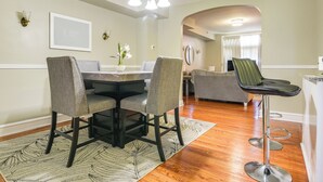 A dining area with a table, chairs, and a chandelier. - Baltimore Vacation Rental - Near JHU & Art Museum! (Baltimore)
