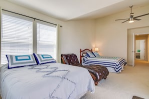 A bedroom with two beds, a ceiling fan, and a door leading to another room. - Bay Views! Luxury Family Retreat in Ocean City (Ocean City)