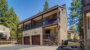 A two-story building with a stone facade, a wooden balcony, and a garage. - Incline Village Retreat Near Skiing & Beaches (Incline Village)