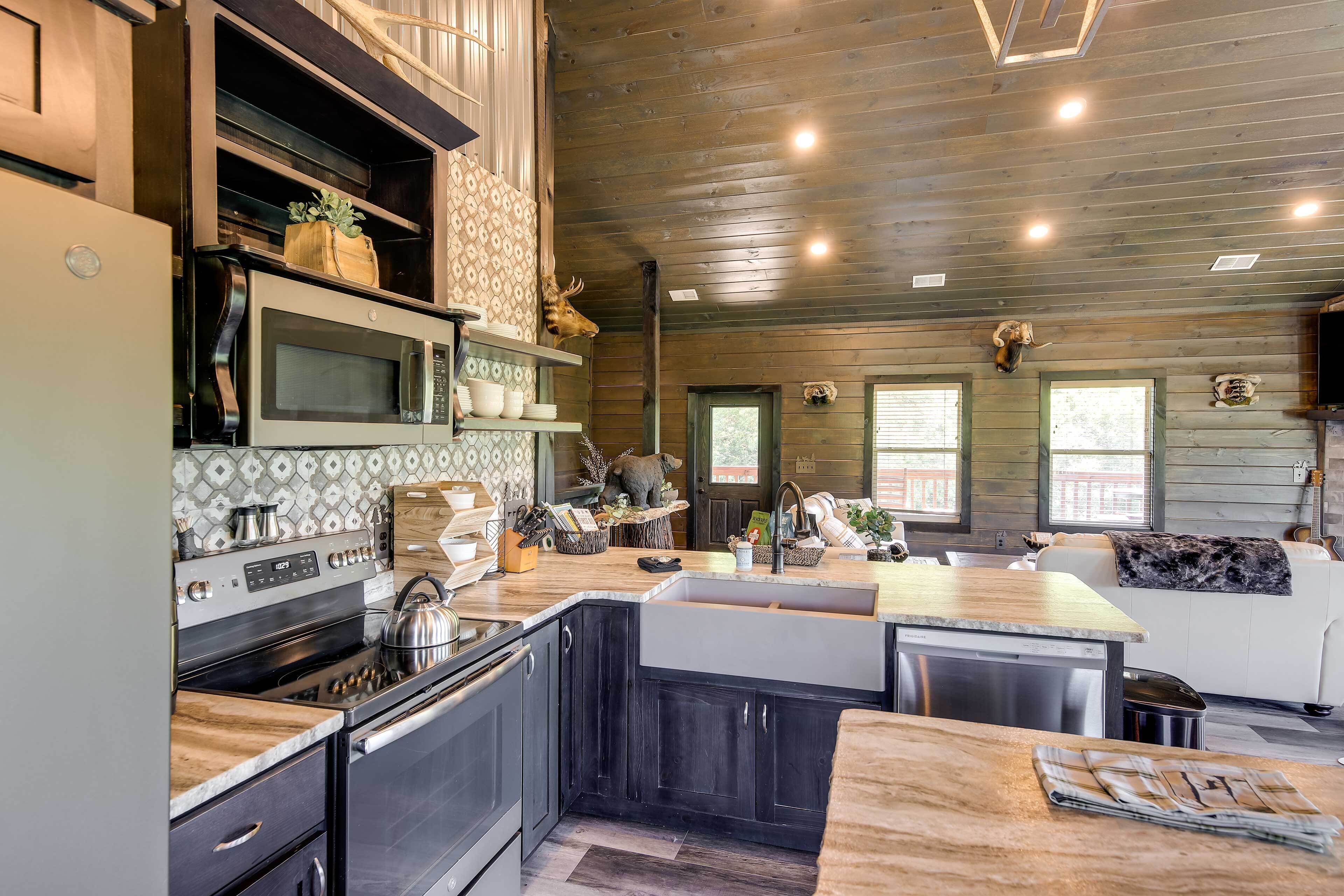 A modern kitchen with a large island, built-in appliances, and a cozy seating area with a fireplace.