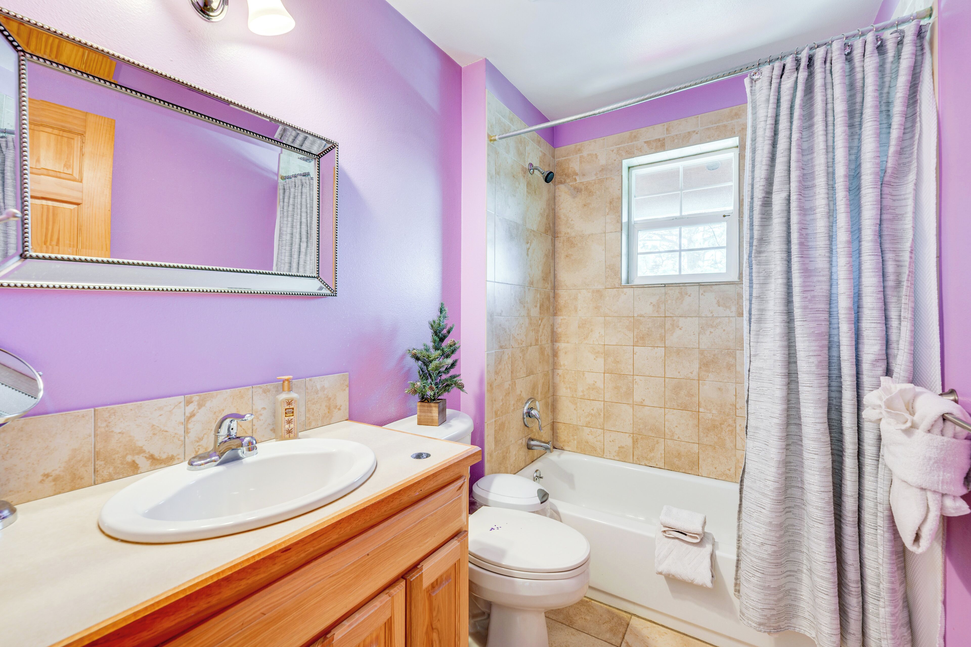 A bathroom with a sink, toilet, and bathtub.