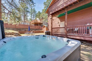 A hot tub in a backyard with a wooden deck and a fenced area. - 2 Mi to Lake Estes: Home w/ Deck & Grill (Estes Park)