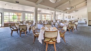 A spacious dining area with multiple tables and chairs, large windows, and a patterned floor. - Palm Desert Resort Country Club Vacation Rental! (Palm Desert)