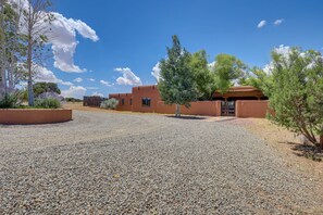 A building with a gravel driveway and a clear blue sky. - Spacious Santa Fe Vacation Rental ~ 5 Mi to Town! (Santa Fe)